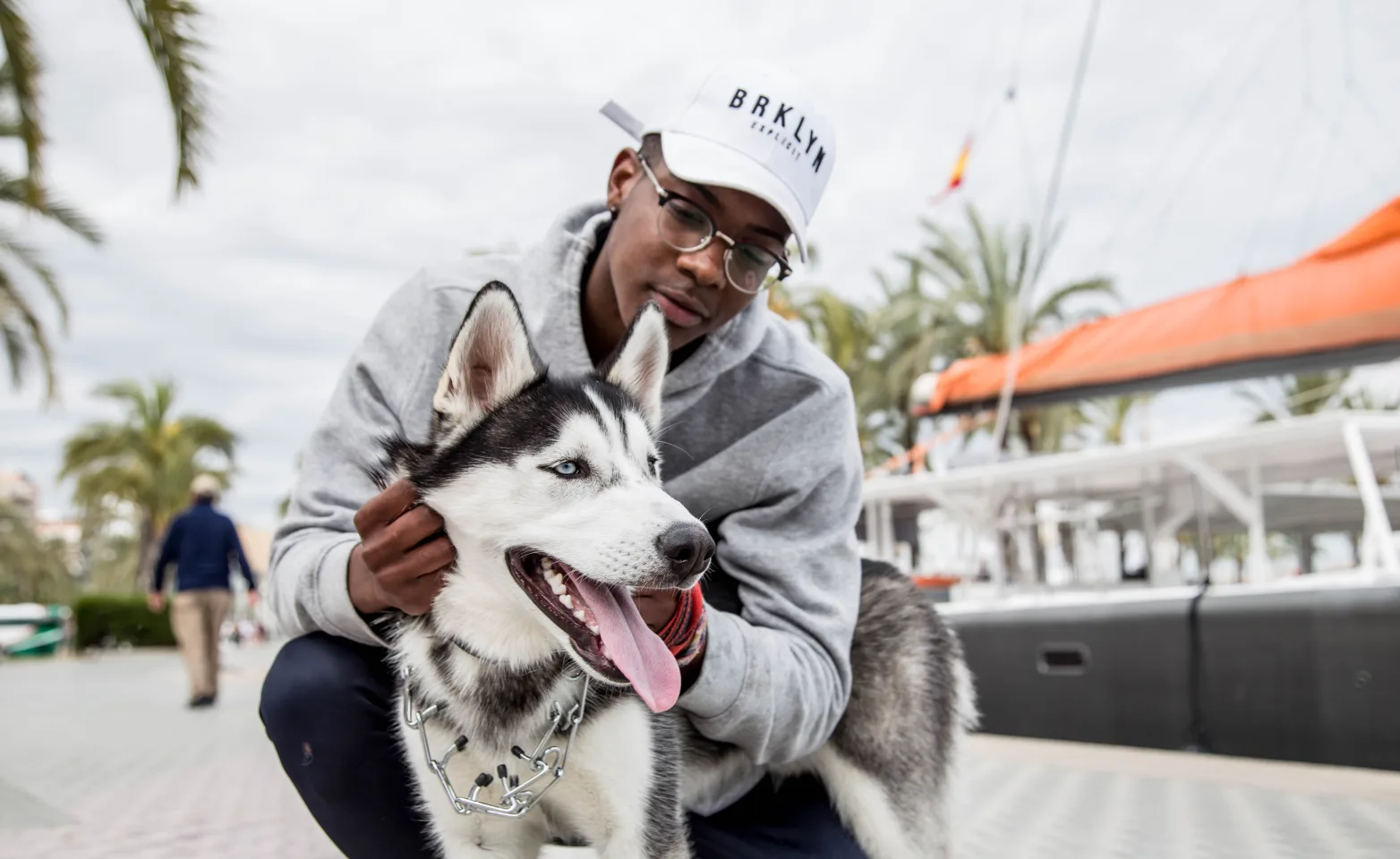 Man holding dog by the dock